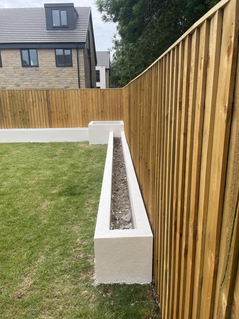 Rendered garden wall with new fencing and landscaping