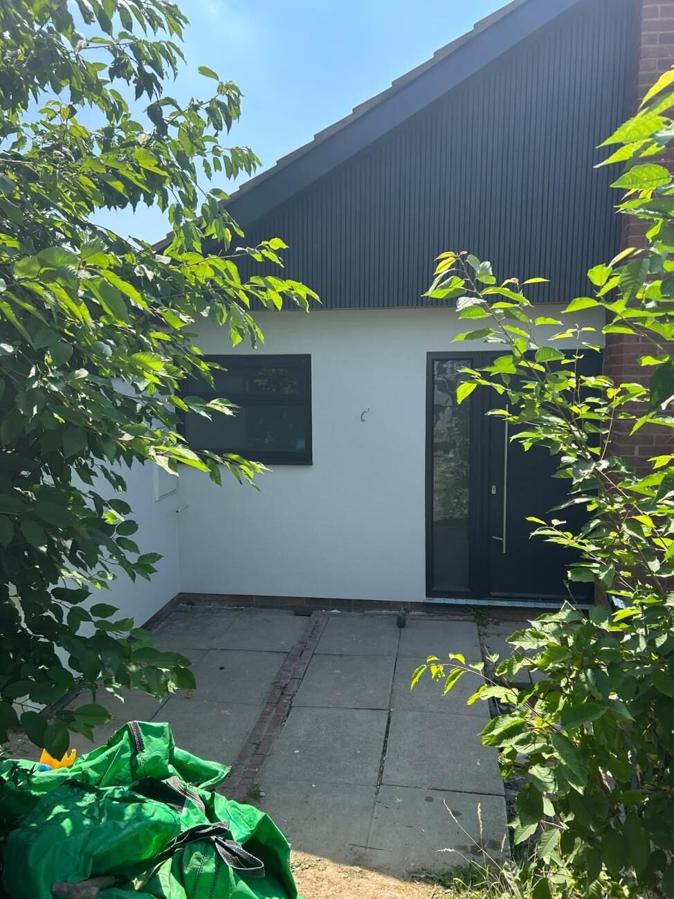 White rendered rear extension with paved patio